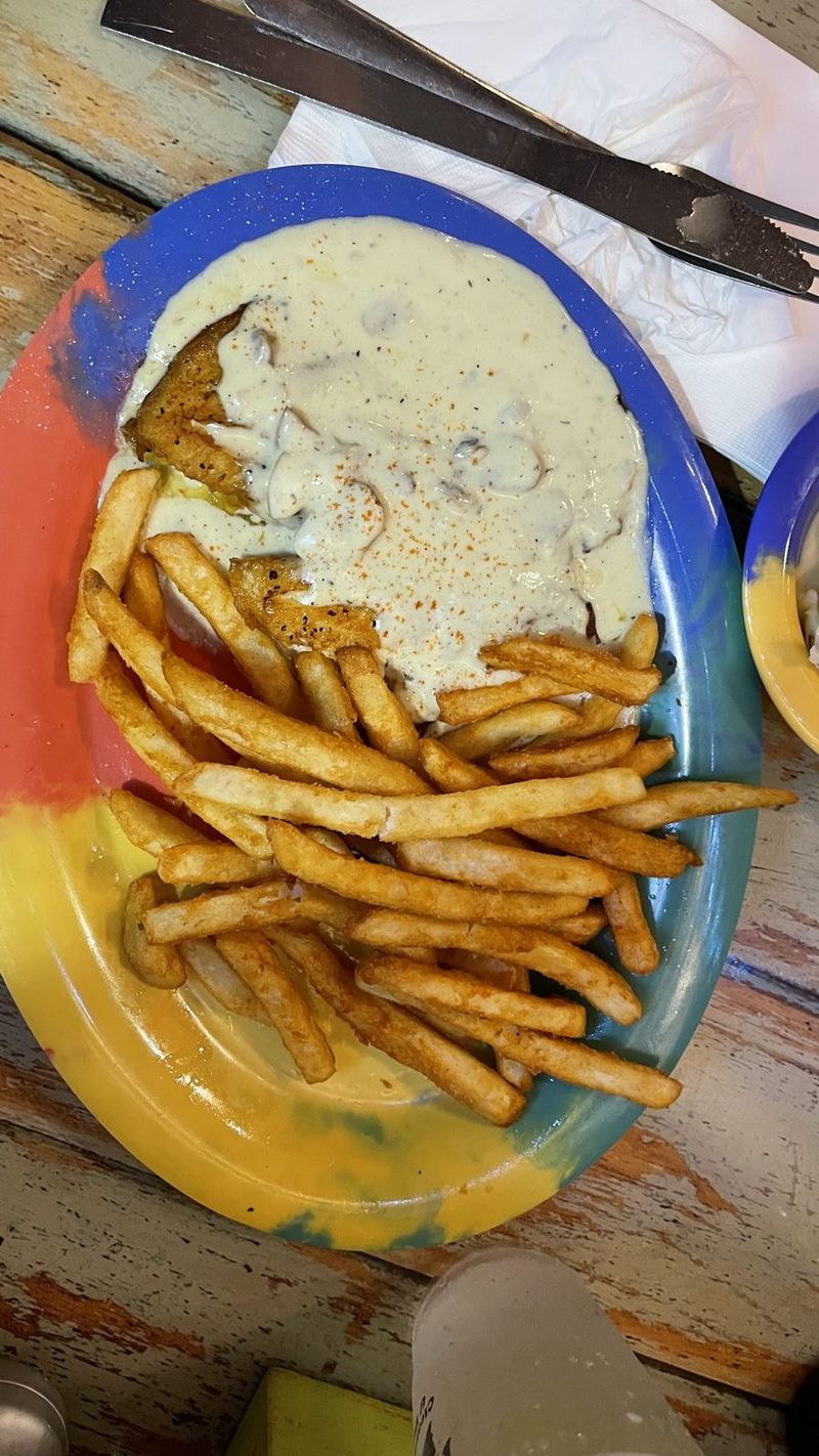 Fish in creamy sauce with fries